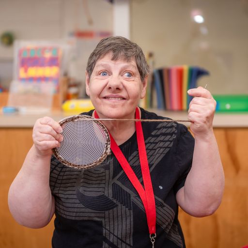 Woman weaving with mesh canvas